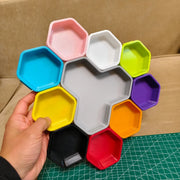 Colourful stackable hex component trays arranged around a central tray