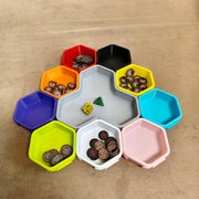 Modular hex trays holding dice and board-game tokens