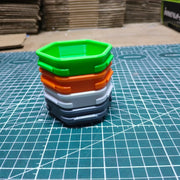 Four small hex component trays stacked together